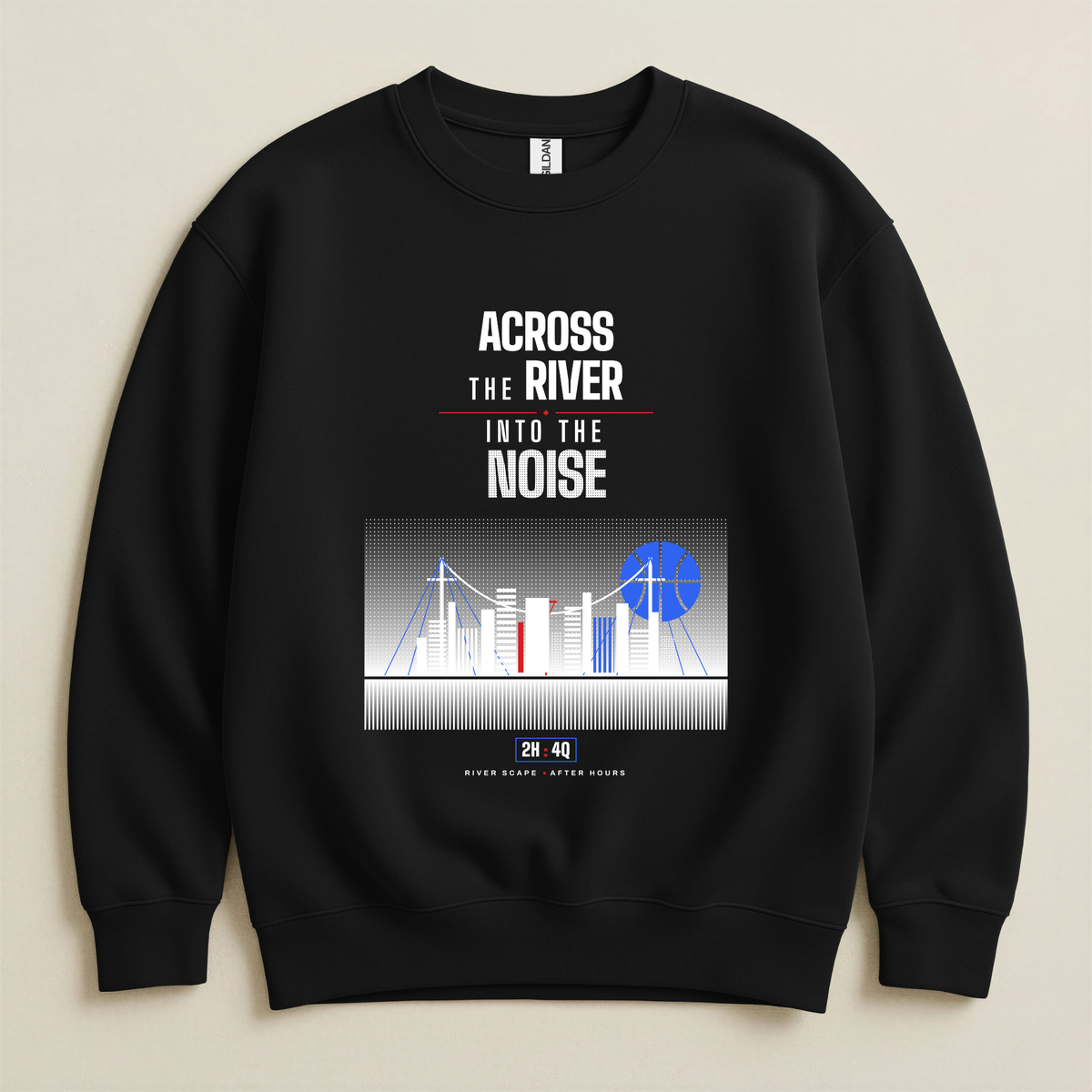 A black crewneck sweatshirt with a graphic print on the front. The print features the text 'ACROSS THE RIVER INTO THE NOISE' in white and red, above a stylized city skyline illustration with a blue basketball shaped moon.