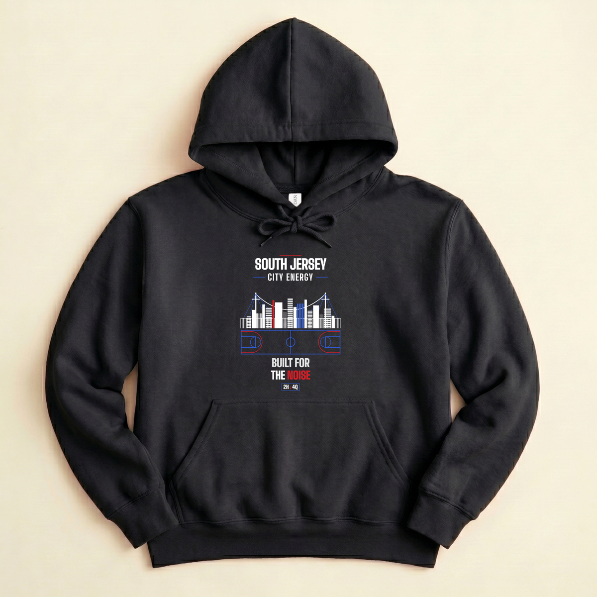 A black pullover hoodie laid flat on a light beige background, featuring a vintage-style sports graphic on the chest with the text '856', '215', a ship illustration, and 'TWO SIDES ONE GAME' in red, white, blue.